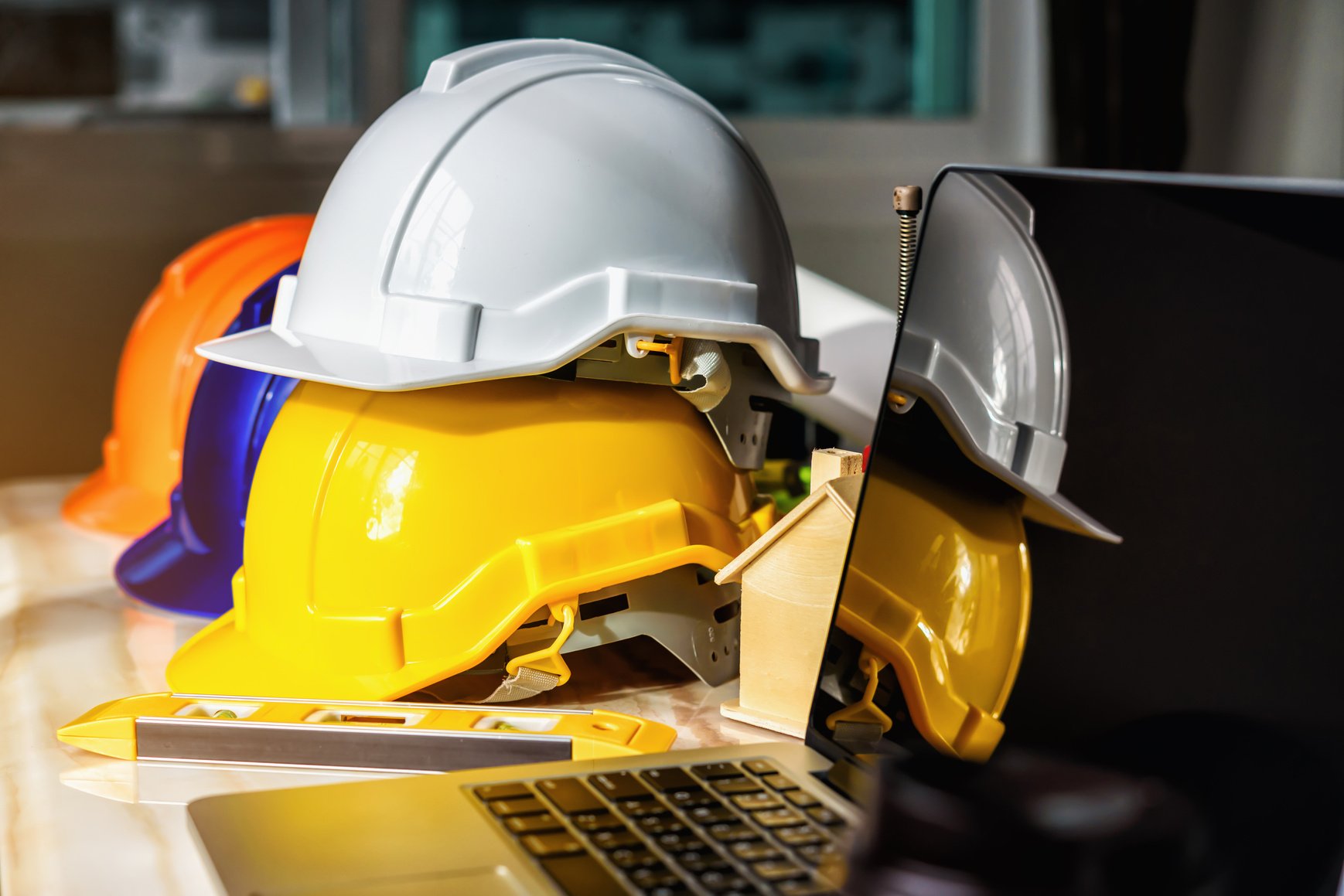 White, Yellow and Blue Safety Helmets for Workers' Safety Projec